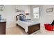 Cozy bedroom with carpet flooring, a single bed, a modern desk and a red chair at 5169 Masser Rd, St Cloud, FL 34772