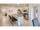 Well-lit kitchen with granite counters, stainless steel appliances, and seating at the breakfast bar at 5169 Masser Rd, St Cloud, FL 34772