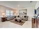 Bright living room featuring stylish sofas, a neutral rug, modern artwork and a large window at 5169 Masser Rd, St Cloud, FL 34772