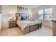 Cozy main bedroom with plush carpeting, a large window, and stylish décor and furnishings at 5169 Masser Rd, St Cloud, FL 34772
