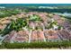 Expansive aerial view of a residential community with manicured lawns, lakes and mature trees at 524 Lobelia Dr, Lake Mary, FL 32746