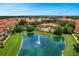 Stunning aerial view featuring the community lake, fountain, clubhouse, pool, and lush green landscaping at 524 Lobelia Dr, Lake Mary, FL 32746