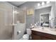 Modern bathroom featuring a glass-enclosed shower, white fixtures, and vanity with a sleek mirror at 524 Lobelia Dr, Lake Mary, FL 32746