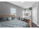 Comfortable bedroom with desk area, natural light, ensuite bathroom, and hardwood flooring at 524 Lobelia Dr, Lake Mary, FL 32746