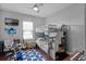 A cozy bedroom featuring a bunk bed with stairs, a desk, musical instruments, and a playful, colorful decor at 524 Lobelia Dr, Lake Mary, FL 32746