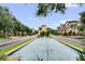 Community entrance showcasing a long fountain feature, well-manicured lawns, and Mediterranean-style architecture at 524 Lobelia Dr, Lake Mary, FL 32746