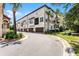 Elegant townhome complex with well-manicured landscaping, private garages, and charming architectural details at 524 Lobelia Dr, Lake Mary, FL 32746