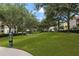 Lush green space with mature trees and walking paths, offering a serene outdoor environment at 524 Lobelia Dr, Lake Mary, FL 32746