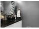 Chic half bath with unique mirror, dark granite countertop, vessel sink, and stylish accessories at 524 Lobelia Dr, Lake Mary, FL 32746