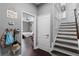 Inviting hallway featuring an entry to a bedroom, a mud room sign, and stairs leading to the upper level at 524 Lobelia Dr, Lake Mary, FL 32746