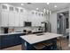 Modern kitchen with stylish white cabinetry, stainless steel appliances, and large quartz island at 524 Lobelia Dr, Lake Mary, FL 32746