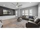 Comfortable living room featuring a modern sectional sofa, custom cabinets and hardwood floors at 524 Lobelia Dr, Lake Mary, FL 32746