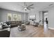 Comfortable living room with a contemporary sectional sofa, wall-mounted TV, and stylish decor at 524 Lobelia Dr, Lake Mary, FL 32746