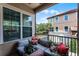 Cozy patio with comfortable seating, colorful cushions, and view of neighborhood buildings and landscaping at 524 Lobelia Dr, Lake Mary, FL 32746