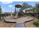 Community playground surrounded by a black metal fence and mature trees, providing a safe recreational space at 524 Lobelia Dr, Lake Mary, FL 32746