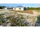 Backyard showing metal roof, new construction, and green and sandy landscaping at 534 Central Ave, Frostproof, FL 33843