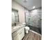 Modern bathroom with a granite-topped vanity and a glass-enclosed shower with tile surround at 534 Central Ave, Frostproof, FL 33843