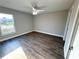 Bedroom featuring wood-look floors, gray walls, ceiling fan, and natural light from the window at 534 Central Ave, Frostproof, FL 33843