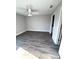 Bedroom featuring wood-look floors, gray walls, ceiling fan, and white trim at 534 Central Ave, Frostproof, FL 33843