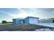 Exterior shot of home featuring blue paint, a metal roof, a driveway and two car garage at 534 Central Ave, Frostproof, FL 33843