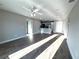 Spacious living room with new wood flooring, ceiling fan, and an open view of the kitchen at 534 Central Ave, Frostproof, FL 33843