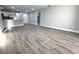 Open-concept living room with new wood flooring and bright, neutral paint at 534 Central Ave, Frostproof, FL 33843
