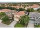 Residential neighborhood featuring terra cotta roofs, manicured lawns, and mature landscaping at 5353 Oakbourne Ave, Davenport, FL 33837