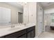 The bathroom features a double sink vanity, with access to the Primary bedroom at 5353 Oakbourne Ave, Davenport, FL 33837