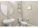 Well-lit half bathroom featuring a pedestal sink and matching decor for a cohesive, stylish look at 5353 Oakbourne Ave, Davenport, FL 33837