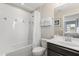 Bathroom showcasing a tub with shower, a single vanity, a mirror and good lighting at 5353 Oakbourne Ave, Davenport, FL 33837