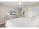 Bright bedroom with closet and dresser features a white comforter and neutral decor at 5353 Oakbourne Ave, Davenport, FL 33837