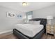 Bedroom featuring a queen-size bed, two framed prints, a lamp, and a bedside table at 5353 Oakbourne Ave, Davenport, FL 33837
