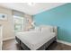 This bedroom features natural light and a calm blue accent wall and matching curtains at 5353 Oakbourne Ave, Davenport, FL 33837
