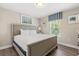 This is a bedroom with a light-colored bed and views through the window at 5353 Oakbourne Ave, Davenport, FL 33837