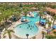 Large community pool featuring a water slide, palm trees, and seating areas at 5353 Oakbourne Ave, Davenport, FL 33837
