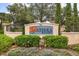 Solterra Resort sign with lush landscaping featuring flowers, plants, and trees at 5353 Oakbourne Ave, Davenport, FL 33837