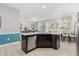 Granite kitchen island with stainless steel dishwasher overlooks dining area and living room for open concept living at 5353 Oakbourne Ave, Davenport, FL 33837