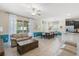 Open living space featuring tile floors, comfortable seating, and direct access to outdoor patio area at 5353 Oakbourne Ave, Davenport, FL 33837
