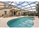 Backyard pool area with a jacuzzi, and outdoor dining with comfortable seating and beautiful landscaping at 5353 Oakbourne Ave, Davenport, FL 33837