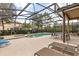 Inviting screened-in pool area with comfortable seating, jacuzzi and clear blue water at 5353 Oakbourne Ave, Davenport, FL 33837