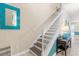 Bright staircase featuring neutral colors and a turquoise mirror and accent pieces at 5353 Oakbourne Ave, Davenport, FL 33837