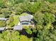 Aerial view of a home with a screened pool and a private dock on the water at 5370 Whispering Pine Cir, St Cloud, FL 34771