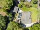 Aerial view of a home with a screened pool and a private dock on the water at 5370 Whispering Pine Cir, St Cloud, FL 34771