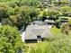 Aerial view of a home with a screened pool and a private dock on the water at 5370 Whispering Pine Cir, St Cloud, FL 34771