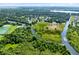 Aerial view of waterfront canals with trees and grass on the shoreline at 5370 Whispering Pine Cir, St Cloud, FL 34771