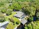 Aerial view of a home with a screened pool and a private dock on the water at 5370 Whispering Pine Cir, St Cloud, FL 34771