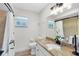 Well-lit bathroom features granite countertops, white cabinets, and tile shower-tub combo at 5370 Whispering Pine Cir, St Cloud, FL 34771