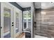 Modern bathroom featuring a glass shower with wood-look tile and natural light from a window at 5370 Whispering Pine Cir, St Cloud, FL 34771