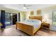 Bright bedroom with wood-look floors and an outdoor view that provides access to the pool and lanai at 5370 Whispering Pine Cir, St Cloud, FL 34771