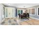 Inviting dining area with modern decor, a stylish rug, and a view to the outdoor living space at 5370 Whispering Pine Cir, St Cloud, FL 34771
